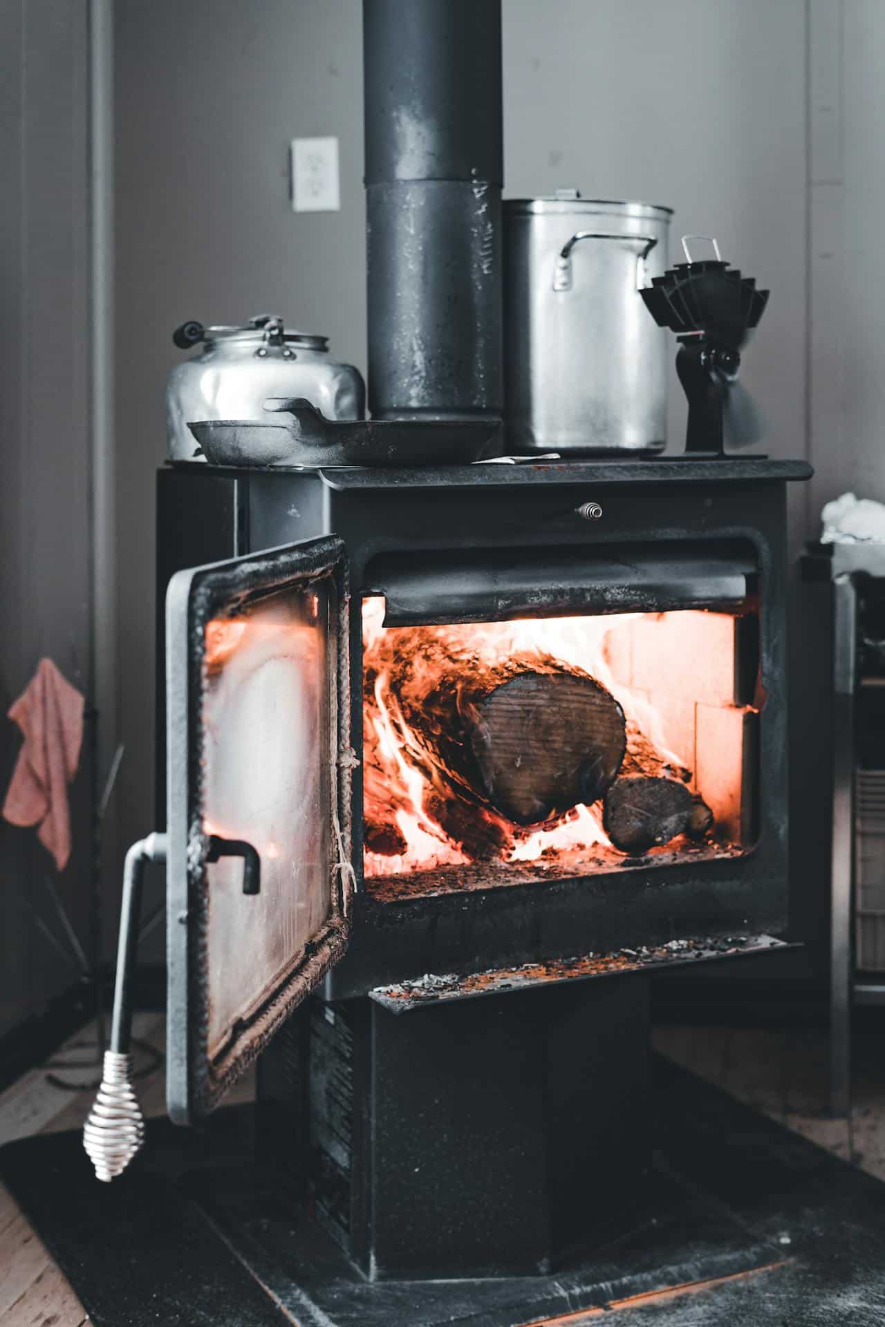 Wood stove with burning fire inside for air quality monitoring in Kitimat.